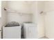 Clean, functional laundry room with washer, dryer, and built-in shelving for storage at 4102 S 186Th Ave, Goodyear, AZ 85338
