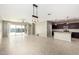 Open-concept living room with a large sliding door leading to the patio and stylish light fixture at 4102 S 186Th Ave, Goodyear, AZ 85338