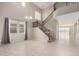 Spacious living room with abundant natural light, staircase, and tile flooring at 4102 S 186Th Ave, Goodyear, AZ 85338