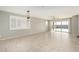 Open living room with tile floors, lots of natural light, and glass doors to backyard at 4102 S 186Th Ave, Goodyear, AZ 85338