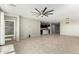 Spacious living room featuring a ceiling fan and an open view to the kitchen area at 4102 S 186Th Ave, Goodyear, AZ 85338