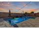 Sparkling pool and spa in this backyard oasis, complete with waterfall feature and string lights at 4102 S 186Th Ave, Goodyear, AZ 85338