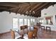 Bright dining room with wood beamed ceiling, rustic tile floor, and access to the backyard at 6701 N Scottsdale Rd # 20, Scottsdale, AZ 85250
