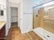 Well-lit bathroom with tile floors, a glass-enclosed shower, and a walk-in closet at 1948 W Busoni Pl, Phoenix, AZ 85023