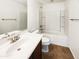 Bright bathroom featuring a single sink vanity, tile flooring, a shower-tub combo, and ample counter space at 1948 W Busoni Pl, Phoenix, AZ 85023