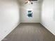 Clean and bright bedroom with carpet, featuring a window for natural light at 1948 W Busoni Pl, Phoenix, AZ 85023