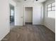 Bedroom features neutral carpet, a window, and a closet with sliding doors at 1948 W Busoni Pl, Phoenix, AZ 85023