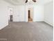 Bright bedroom with neutral carpeting, white walls, ceiling fan, and access to a walk-in closet at 1948 W Busoni Pl, Phoenix, AZ 85023