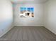 Bedroom featuring neutral carpeting, a bright window, and ample natural light at 1948 W Busoni Pl, Phoenix, AZ 85023