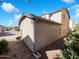 A view of the rear of the property showing the stucco exterior and landscaping at 1948 W Busoni Pl, Phoenix, AZ 85023
