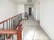 Upstairs hallway features wood and iron railing and neutral carpeting, leading to various rooms at 1948 W Busoni Pl, Phoenix, AZ 85023