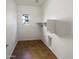 Bright laundry room features tile floor, window, and convenient hookups for washer and dryer at 1948 W Busoni Pl, Phoenix, AZ 85023