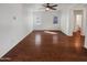 Large living room with wood flooring, two windows and neutral colors, creating a bright and airy atmosphere at 1948 W Busoni Pl, Phoenix, AZ 85023