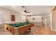 The game room features a pool table, dart board, natural lighting, and neutral paint at 41229 W Laramie Rd, Maricopa, AZ 85138