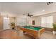 Spacious game room with a pool table, neutral paint, tile flooring and natural light at 41229 W Laramie Rd, Maricopa, AZ 85138
