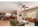 Open concept living room and kitchen with stainless steel appliances, neutral paint and plenty of natural light at 41229 W Laramie Rd, Maricopa, AZ 85138