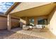 Covered patio with modern patio furniture and a view of the backyard at 41229 W Laramie Rd, Maricopa, AZ 85138