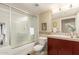 Bright bathroom showcases a shower-tub combo with glass doors and a vanity with ample storage at 114 W Adams St # 506, Phoenix, AZ 85003