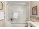 Well-lit bathroom with a shower-tub, and ceramic tile, features a sliding glass door at 114 W Adams St # 506, Phoenix, AZ 85003