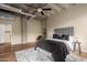 Spacious bedroom features a modern ceiling fan, exposed ductwork, and sleek hardwood flooring at 114 W Adams St # 506, Phoenix, AZ 85003