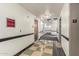 Hallway with tile floors, white walls and black accent trim and signage to unit numbers at 114 W Adams St # 506, Phoenix, AZ 85003