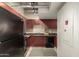 Kitchen with stainless steel appliances, granite countertops, and maroon colored wood cabinets at 114 W Adams St # 506, Phoenix, AZ 85003