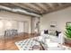 Spacious living room with concrete ceilings, exposed ductwork, and hardwood floors open to a dining area at 114 W Adams St # 506, Phoenix, AZ 85003