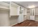 Custom walk-in closet with wooden floors, designed with built-in shelving and drawers for organized storage at 114 W Adams St # 506, Phoenix, AZ 85003