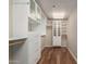 Large closet with wooden floors, includes a variety of storage options with cabinets, drawers, and shelves at 114 W Adams St # 506, Phoenix, AZ 85003