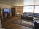 Living room with sectional sofa and large TV at 10307 W Oakmont Dr, Sun City, AZ 85351
