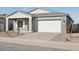 Gray exterior boasts a two-car garage and landscaping at 11458 E Utah Ave, Mesa, AZ 85212