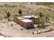 A beautiful aerial view of a detached house with desert landscaping, two garage doors and a large flat lot at 22633 W Yellow Bird Ln, Wittmann, AZ 85361