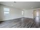 Spacious living room with wood-look floors and large windows at 35176 N Lead Way, San Tan Valley, AZ 85144