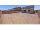 View of the expansive, unfurnished backyard surrounded by brick fencing at 17626 W Oregon Ave, Litchfield Park, AZ 85340
