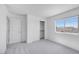Bright bedroom with window and carpet, and closet with sliding doors at 17626 W Oregon Ave, Litchfield Park, AZ 85340