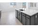 Gray kitchen island with a sink and seating with a white countertop and tile floors at 17626 W Oregon Ave, Litchfield Park, AZ 85340