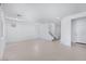 Bright, open-concept living room with tile flooring and a staircase at 17626 W Oregon Ave, Litchfield Park, AZ 85340