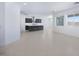 Open living area with tile floors leading to the kitchen with stainless steel appliances and center island at 17626 W Oregon Ave, Litchfield Park, AZ 85340