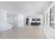 Bright and spacious living area with tile floors leading to a kitchen with stainless steel appliances and a center island at 17626 W Oregon Ave, Litchfield Park, AZ 85340