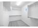 Walk-in closet offering ample storage with shelves and rods for organized clothing and accessories at 17626 W Oregon Ave, Litchfield Park, AZ 85340