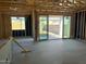 Unfinished interior showcasing exposed beams, sliding glass doors to backyard, and bright natural light at 7682 W Saddlehorn Rd, Peoria, AZ 85383