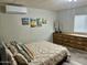 Cozy bedroom featuring a queen bed, decorative artwork, and a bright window at 9427 E University Dr # 46, Mesa, AZ 85207
