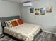 Comfortable bedroom featuring a queen bed, decorative artwork, and minimalist decor at 9427 E University Dr # 46, Mesa, AZ 85207