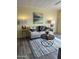 Comfortable living room showcasing a neutral sofa, patterned pillows, and a round coffee table at 9427 E University Dr # 46, Mesa, AZ 85207