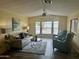 Open living space with comfortable seating, decorative lamps, and large windows for ample light at 9427 E University Dr # 46, Mesa, AZ 85207