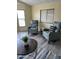 Bright living area with two armchairs, a round table, and natural light from the windows at 9427 E University Dr # 46, Mesa, AZ 85207