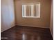 Bright bedroom with wood-look floors and window coverings at 11020 N 45 Ave, Glendale, AZ 85304