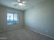 Simple bedroom with ceiling fan and carpet at 18255 W Carlota Ln, Surprise, AZ 85387