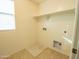 Laundry room with built-in shelving and drain at 18255 W Carlota Ln, Surprise, AZ 85387