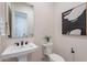 Modern powder room with a sleek pedestal sink, stylish fixtures, and elegant decor to add a modern touch at 23978 S 218Th Pl, Queen Creek, AZ 85142